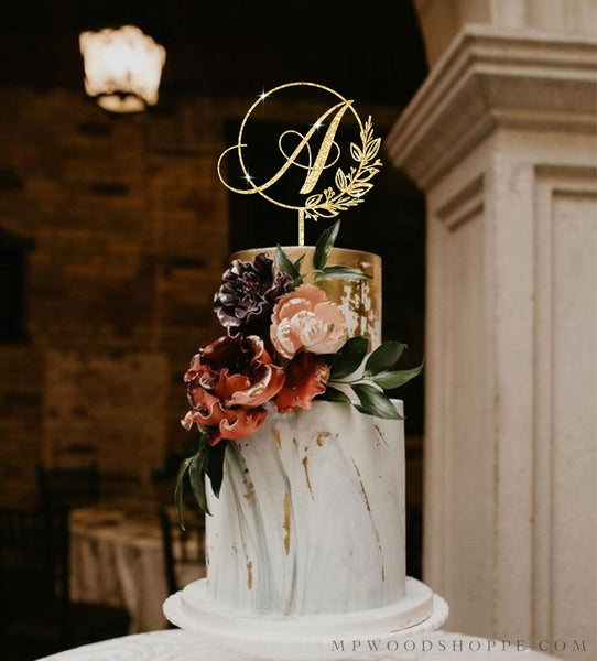 Cake topper for wedding with initial and botanical frame.