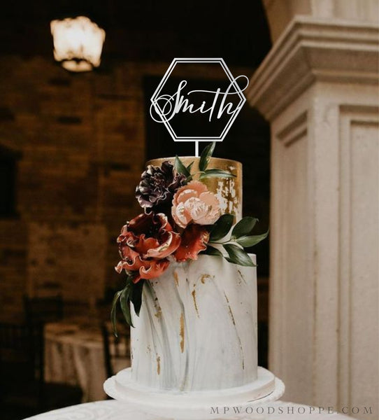 Modern cake topper for wedding with geometric frame and calligraphy name.