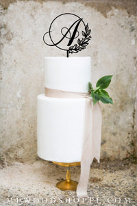 Cake topper for wedding with initial and botanical frame.