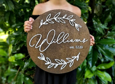 Wood sign with last name and botanical design